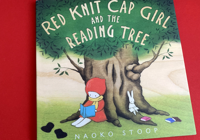 Red kni cap girl and the reading tree home